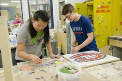 Middle school students working with tiles