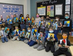 Class holding their Halloween art projects