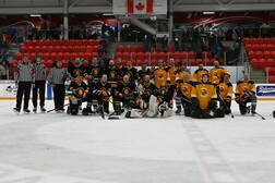 The Flying Fathers Hockey Club, RDCRS Staff Selects Hockey Team, and referees pose for a group photo at Servus Arena post game on February 12.