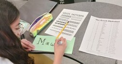 St. Marguerite Bourgeoys Catholic School grade 6 student learning to write their name in Greek